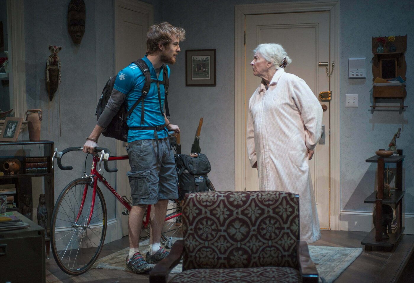 A young man with a bicycle talks with an older woman in a nightgown in 4000 Miles
