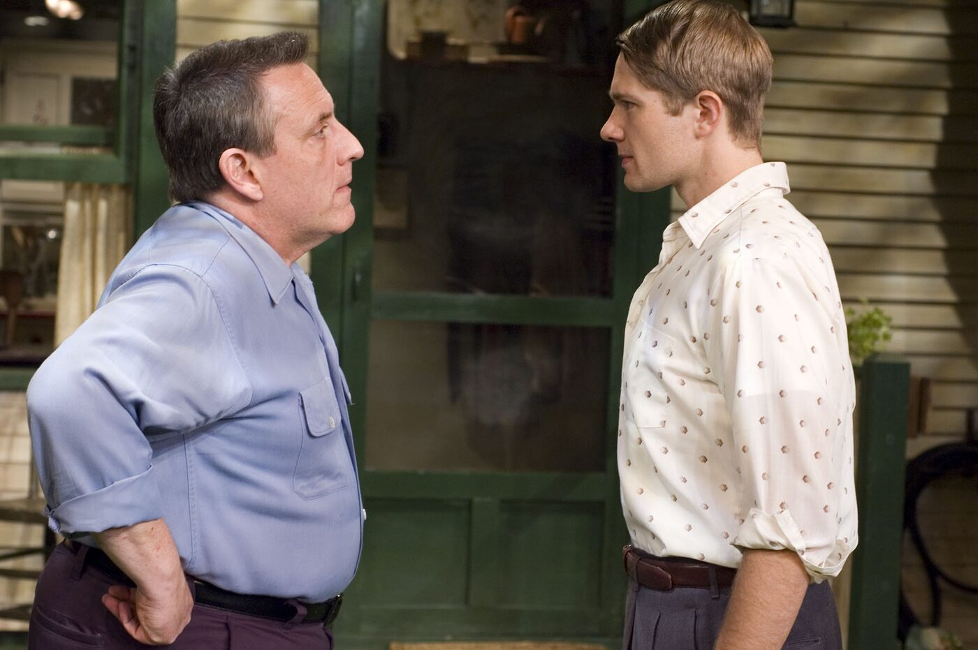 Two actors face each other in the yard in All My Sons