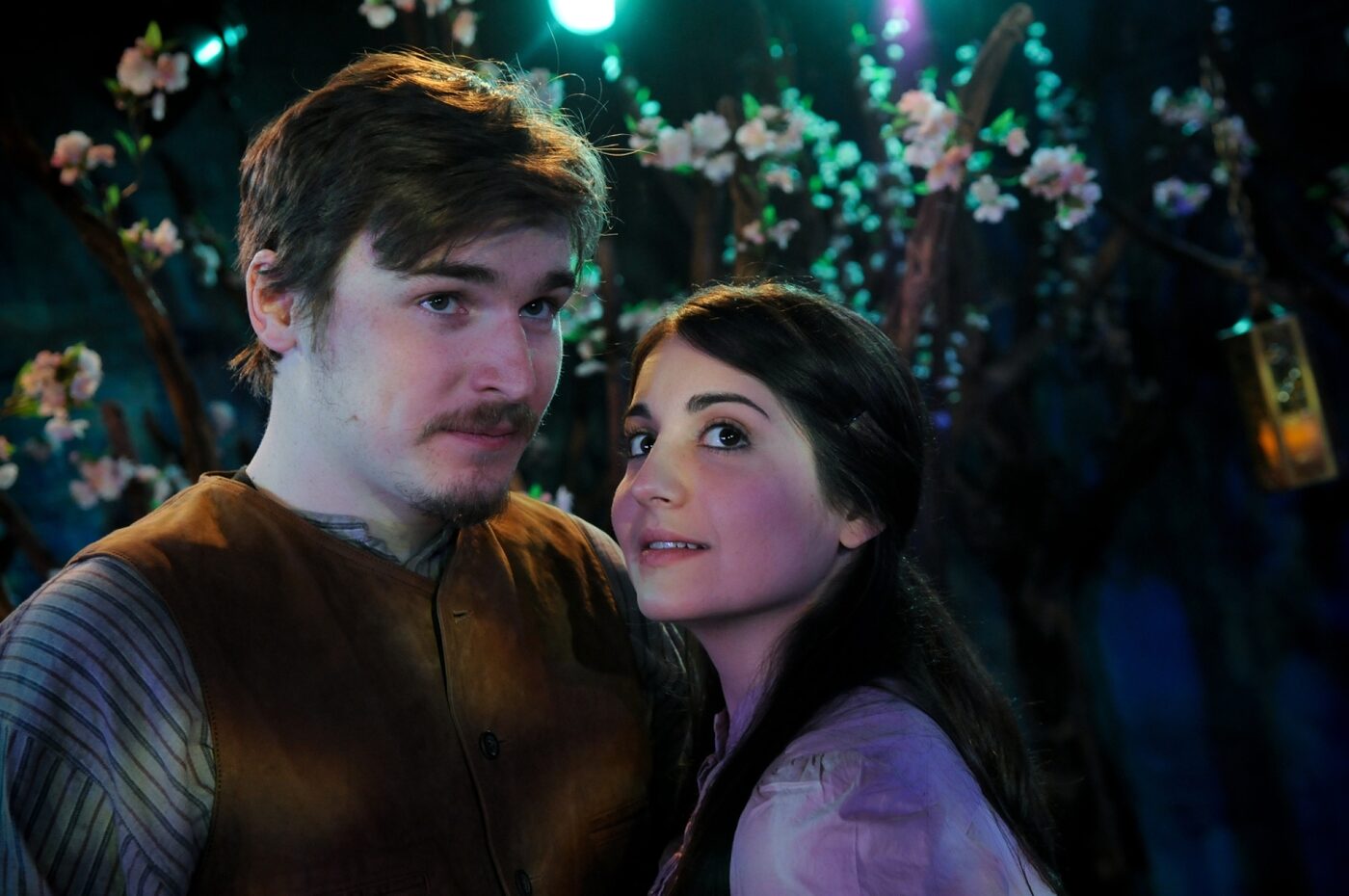 Two actors sharing a warm moment outdoors in Cherry Orchard