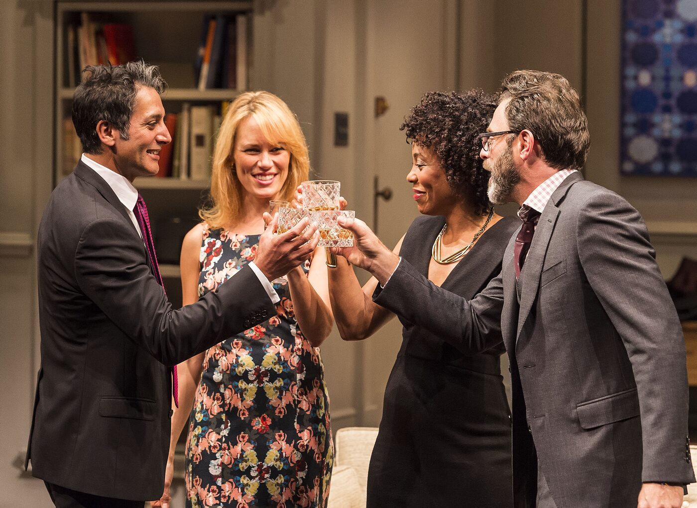 Four characters raising a toast in Disgraced