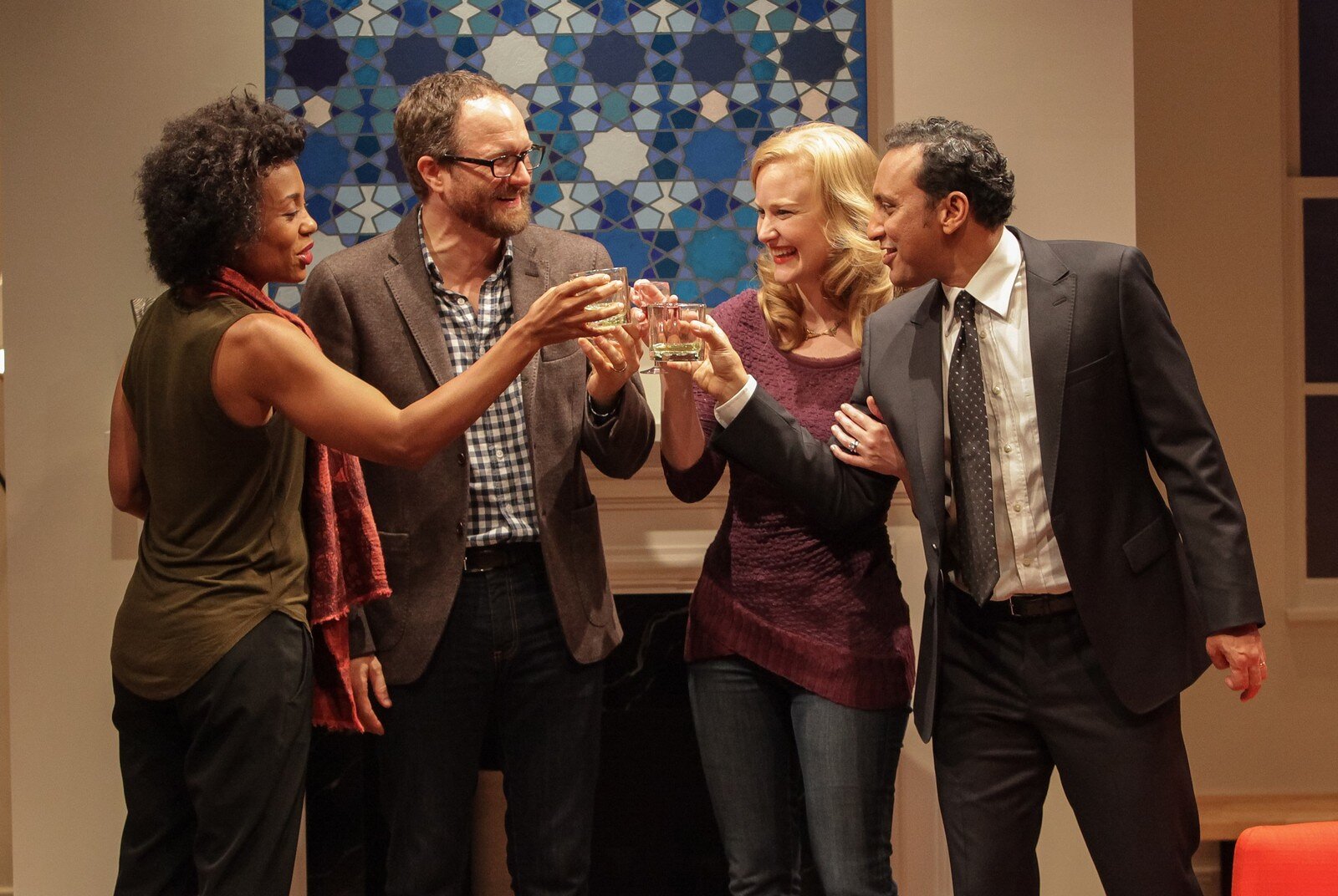The full cast raises a toast together in the living room of Disgraced