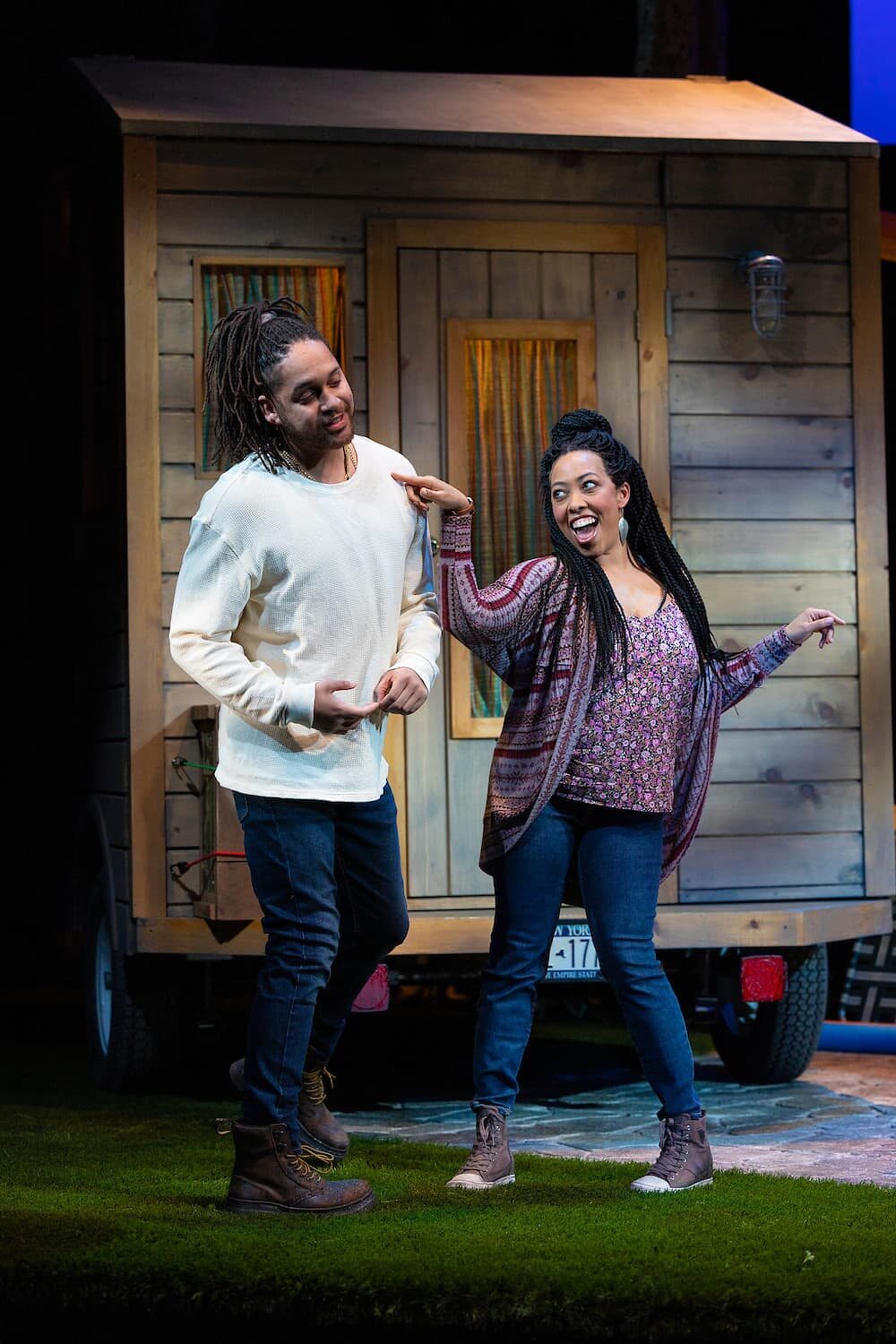 Two actors in front of the wooden trailer in Our Daughters, Like Pillars