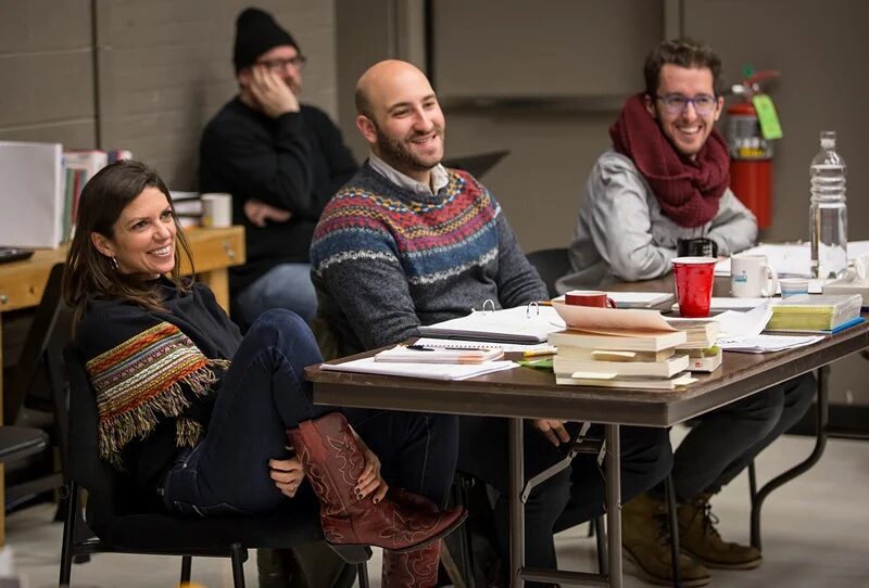 Kimberly Senior laughing with three cast members at the table read for Disgraced