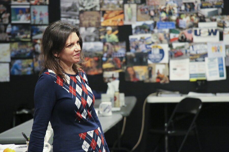 Kimberly Senior smiling in front of the research board in the Sweat rehearsal room