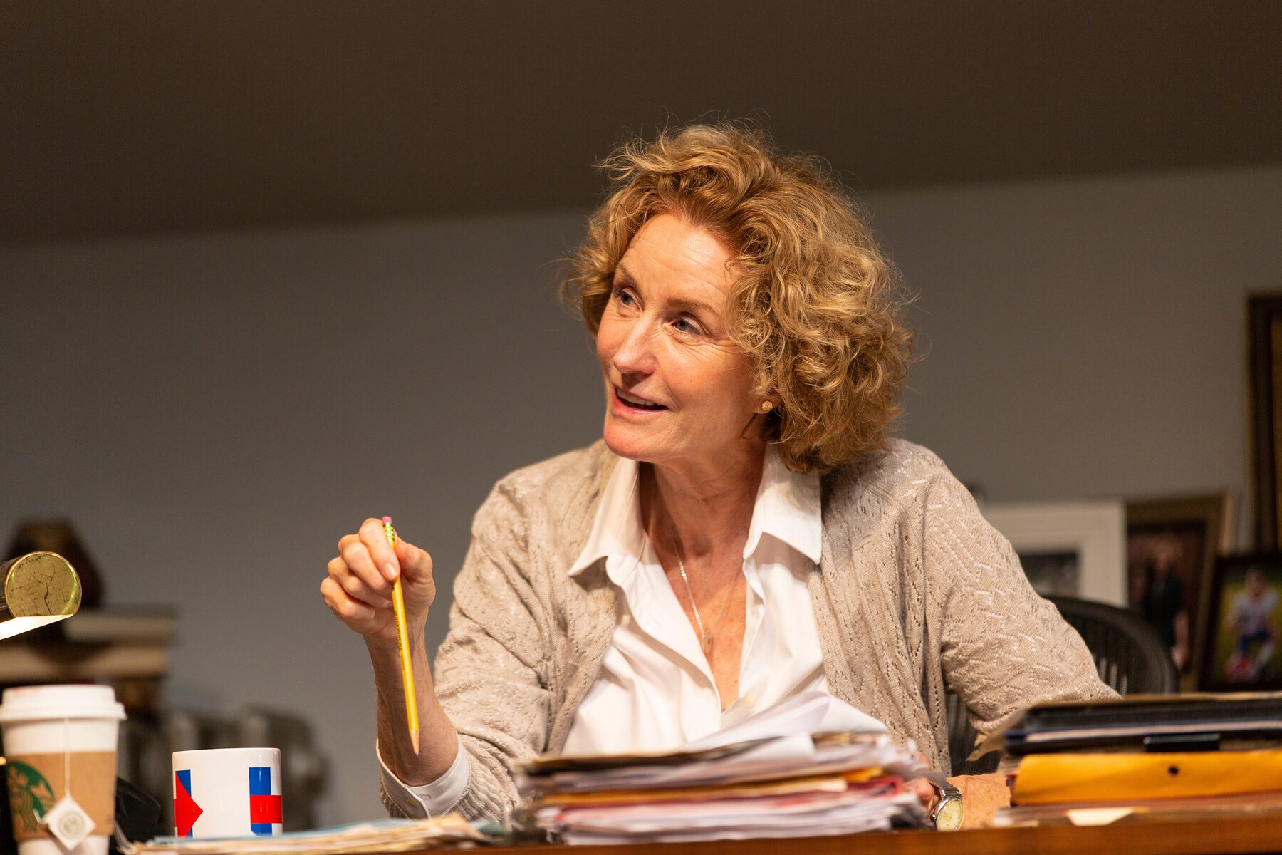 The professor at her desk, pencil in hand