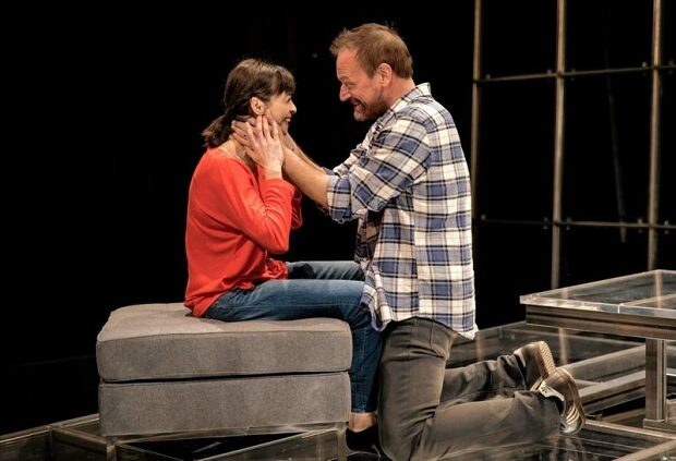 Charin Alvarez and Mark L. Montgomery on the sofa in The Scene