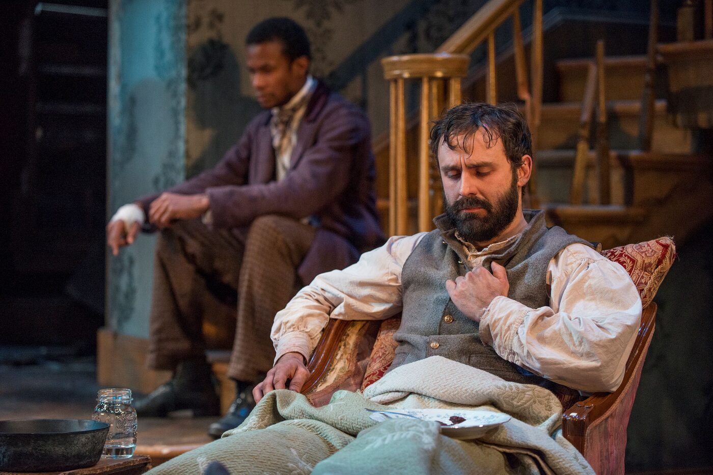 Two men in a ruined Civil War-era parlor in The Whipping Man
