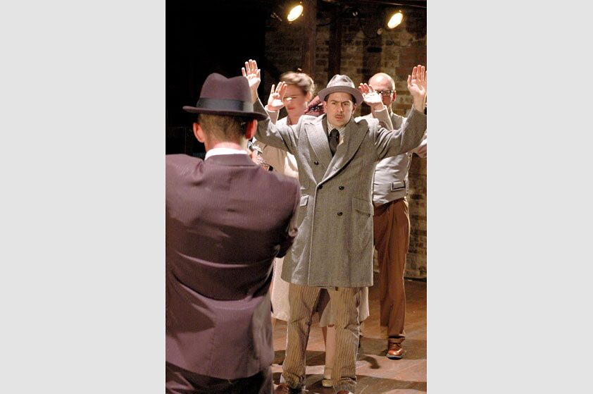A group of men with hands raised during a holdup scene in Thieves Like Us